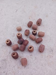Handcrafting rings and bracelets from olive pits.
